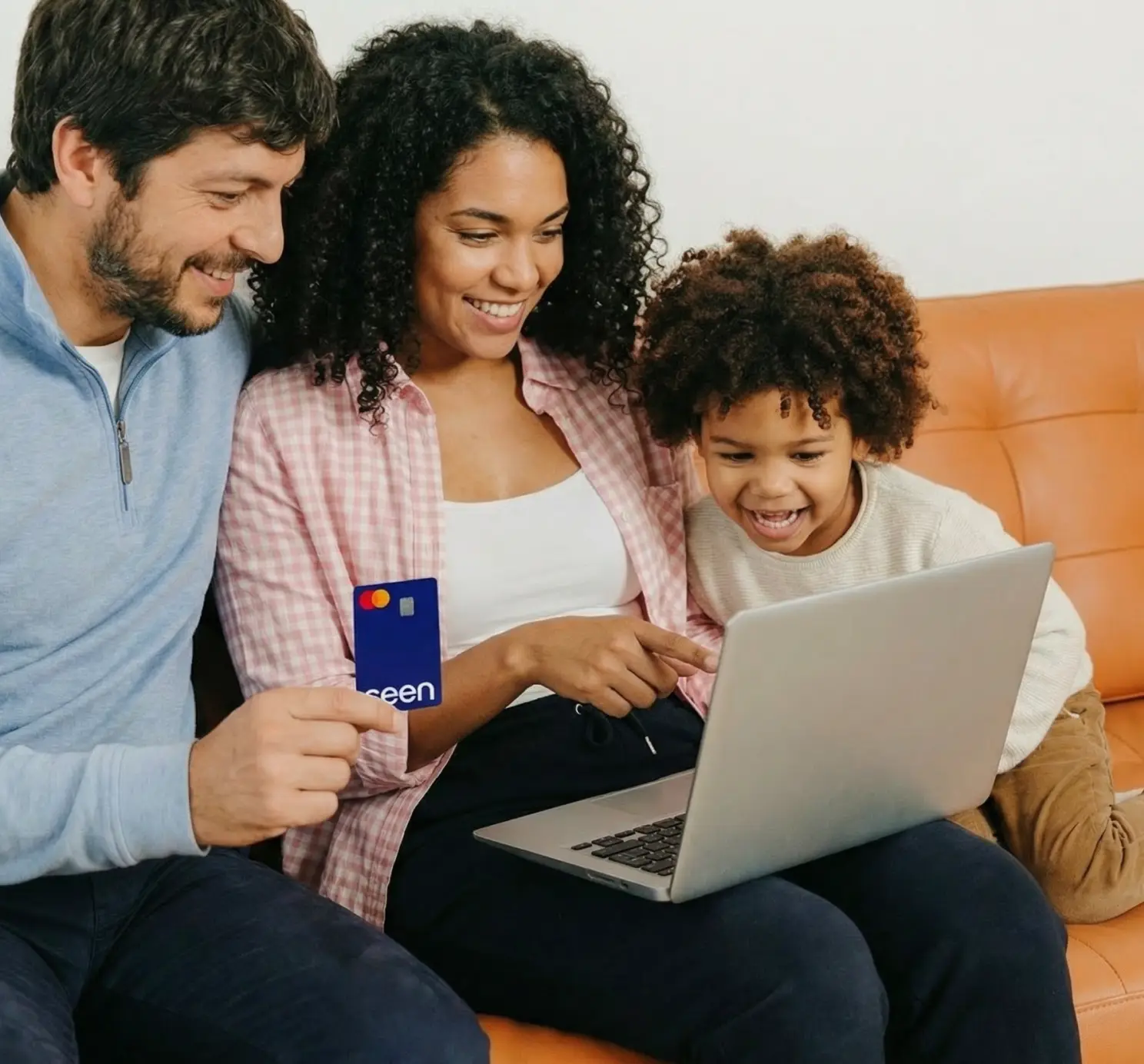 Person smiling while using a Seen credit card